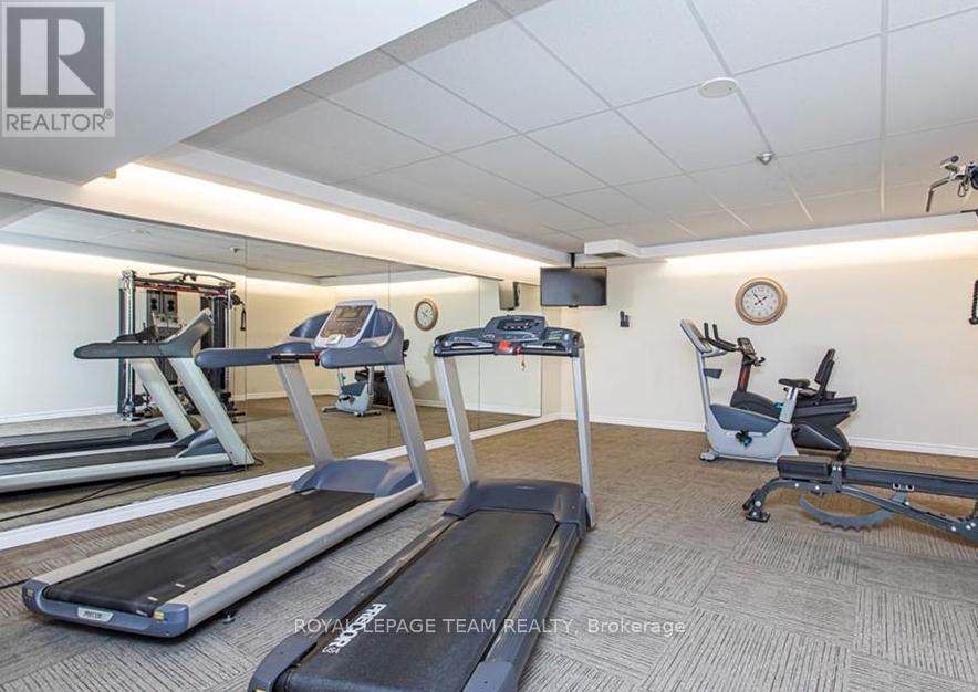A gym with treadmills, elliptical machines, and a stationary bike.
