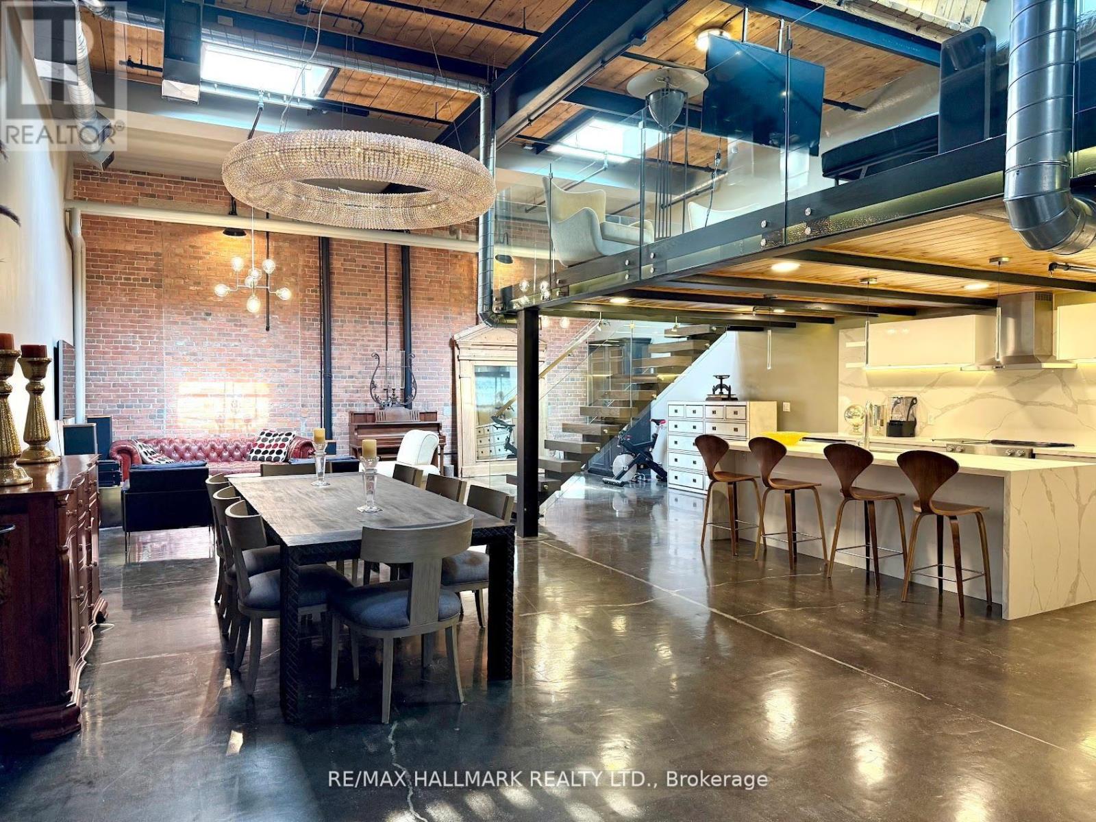 A modern kitchen and dining area with a large table and chairs.