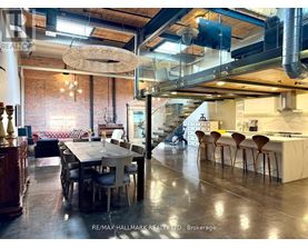 A modern kitchen and dining area with a large table and chairs.