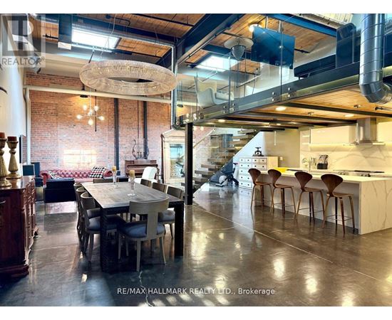 A modern kitchen and dining area with a large table and chairs.
