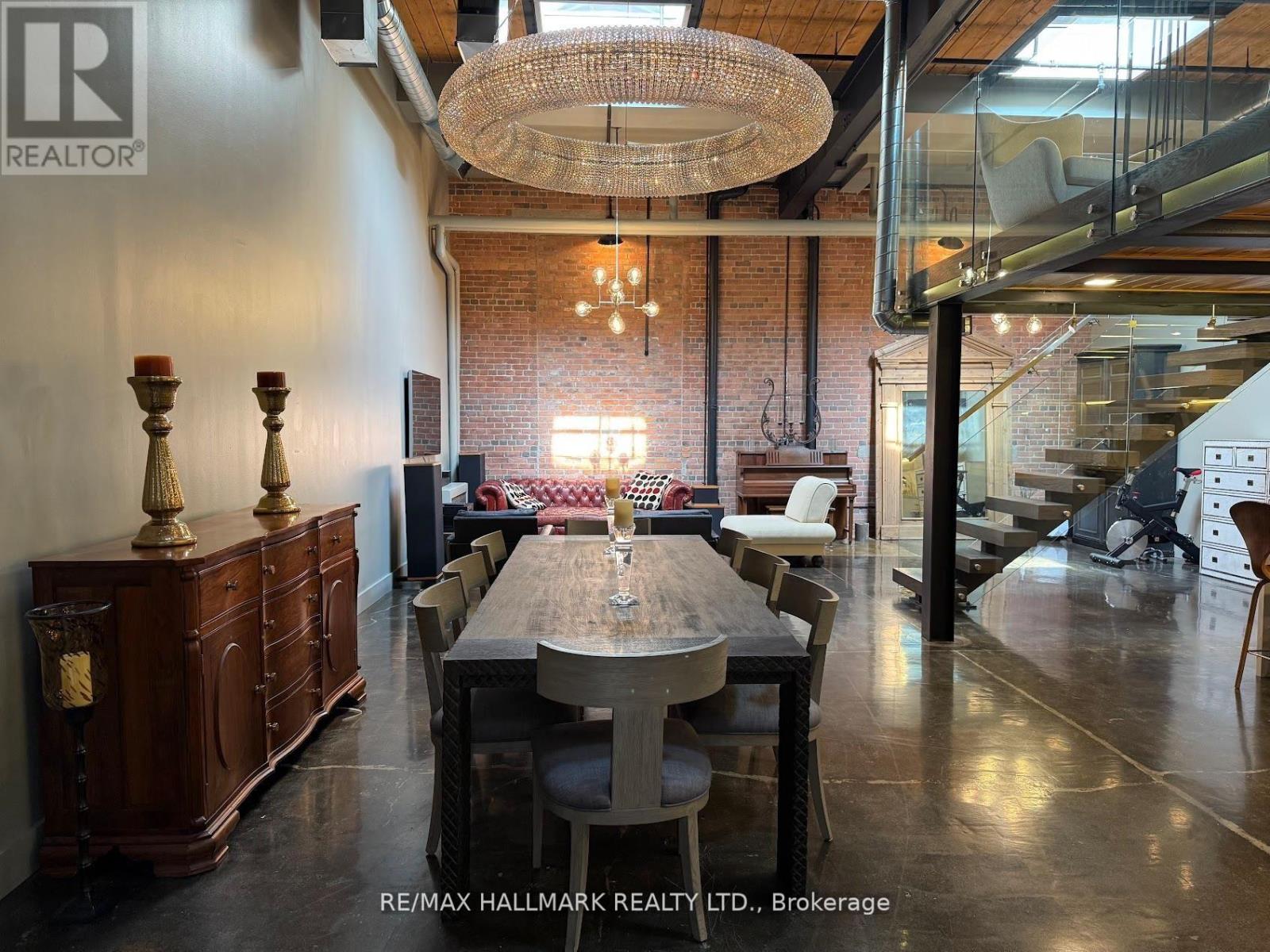 A dining room with a wooden table and chairs.