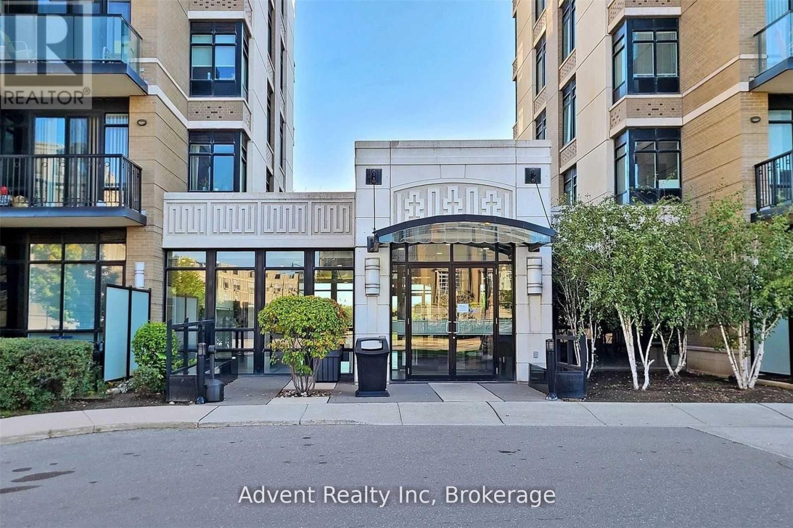 The front of a building with the sign "Advent Realty Inc, Brokerage" on it.