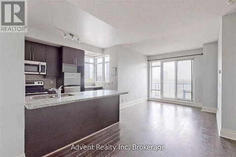 A kitchen with a counter top and a sink.