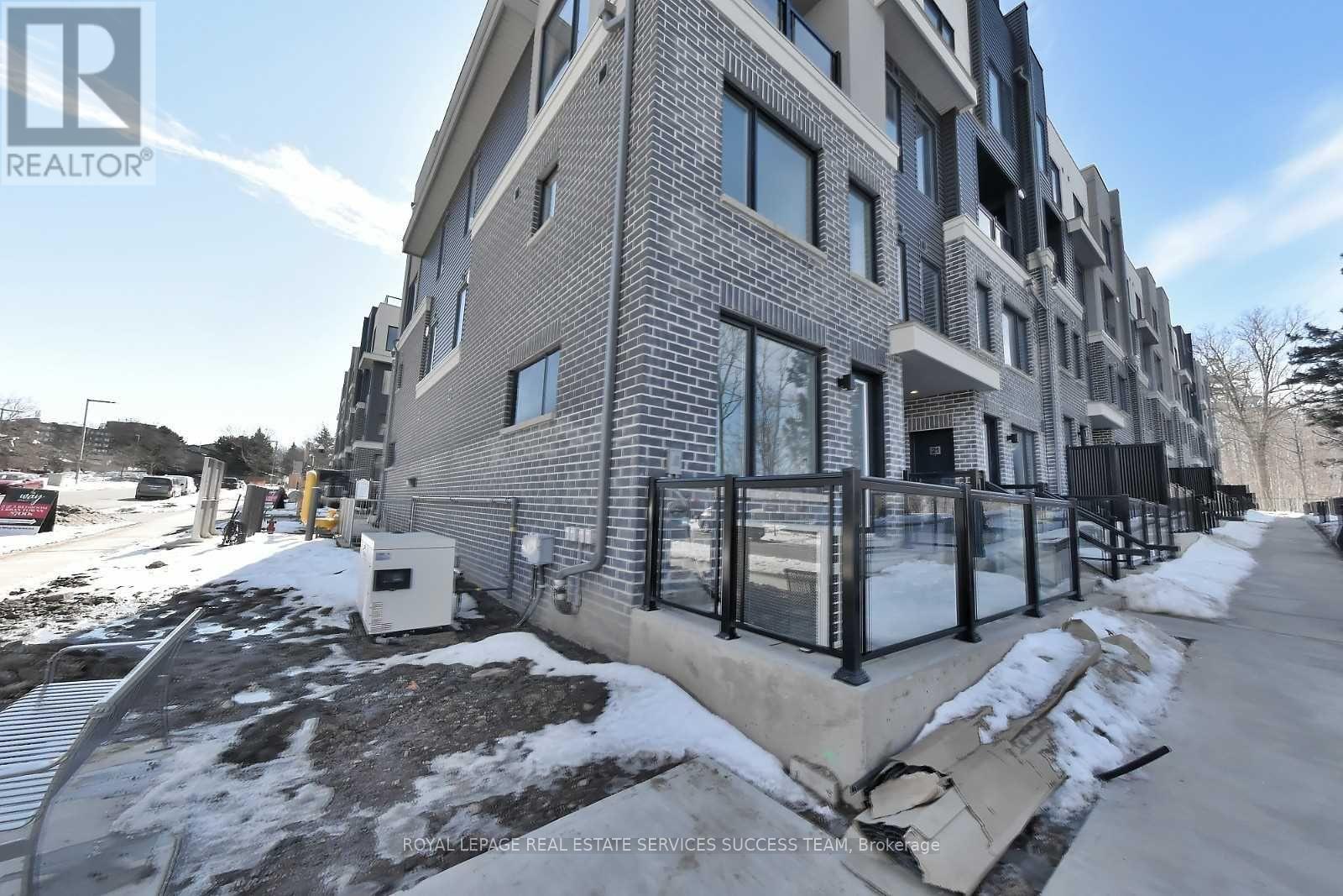 A modern apartment building with a glass railing in front.