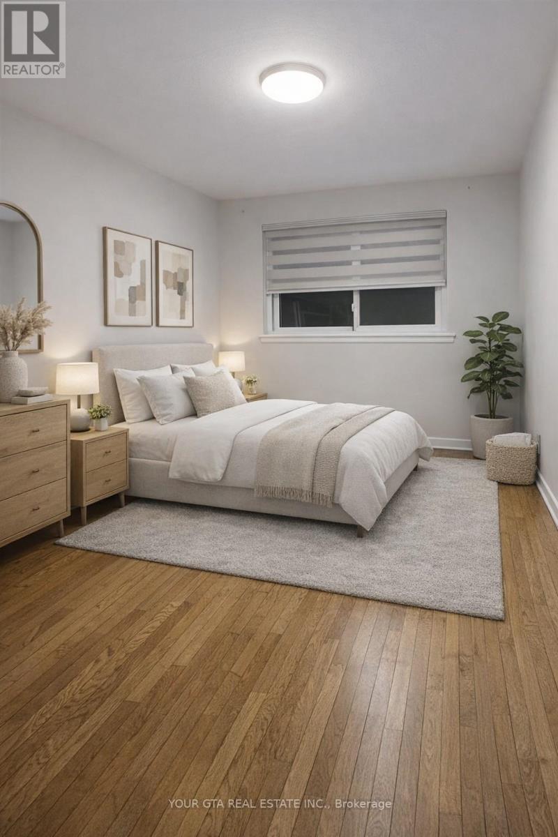 A bedroom with a large bed, a nightstand, and a plant.