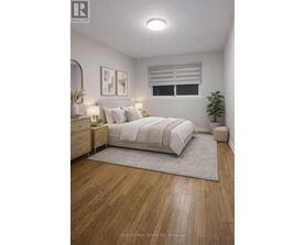 A bedroom with a large bed, a nightstand, and a plant.