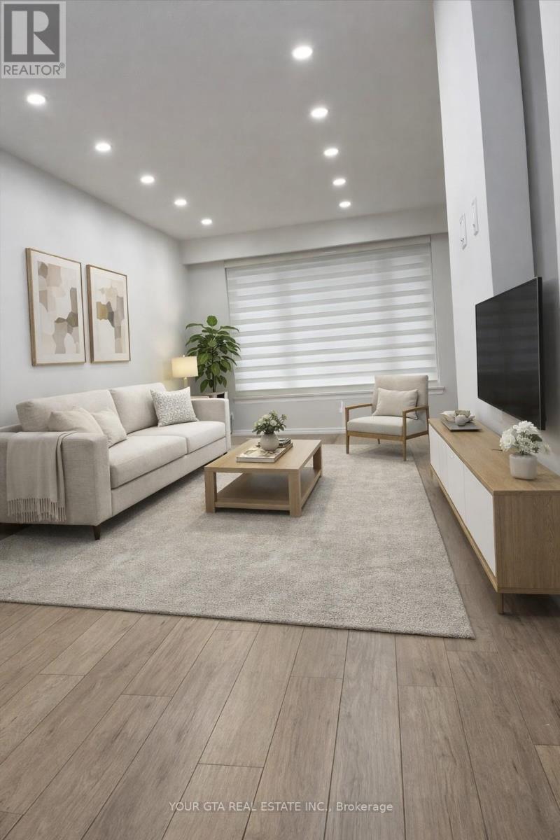 A modern living room with a white couch, a wooden coffee table, and a flat-screen TV mounted on the wall.