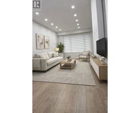A modern living room with a white couch, a wooden coffee table, and a flat-screen TV mounted on the wall.
