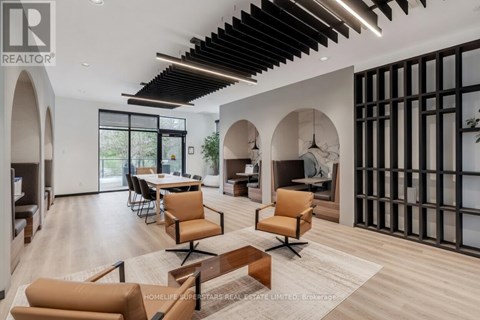 A modern living room with a dining area and a kitchen in the background.