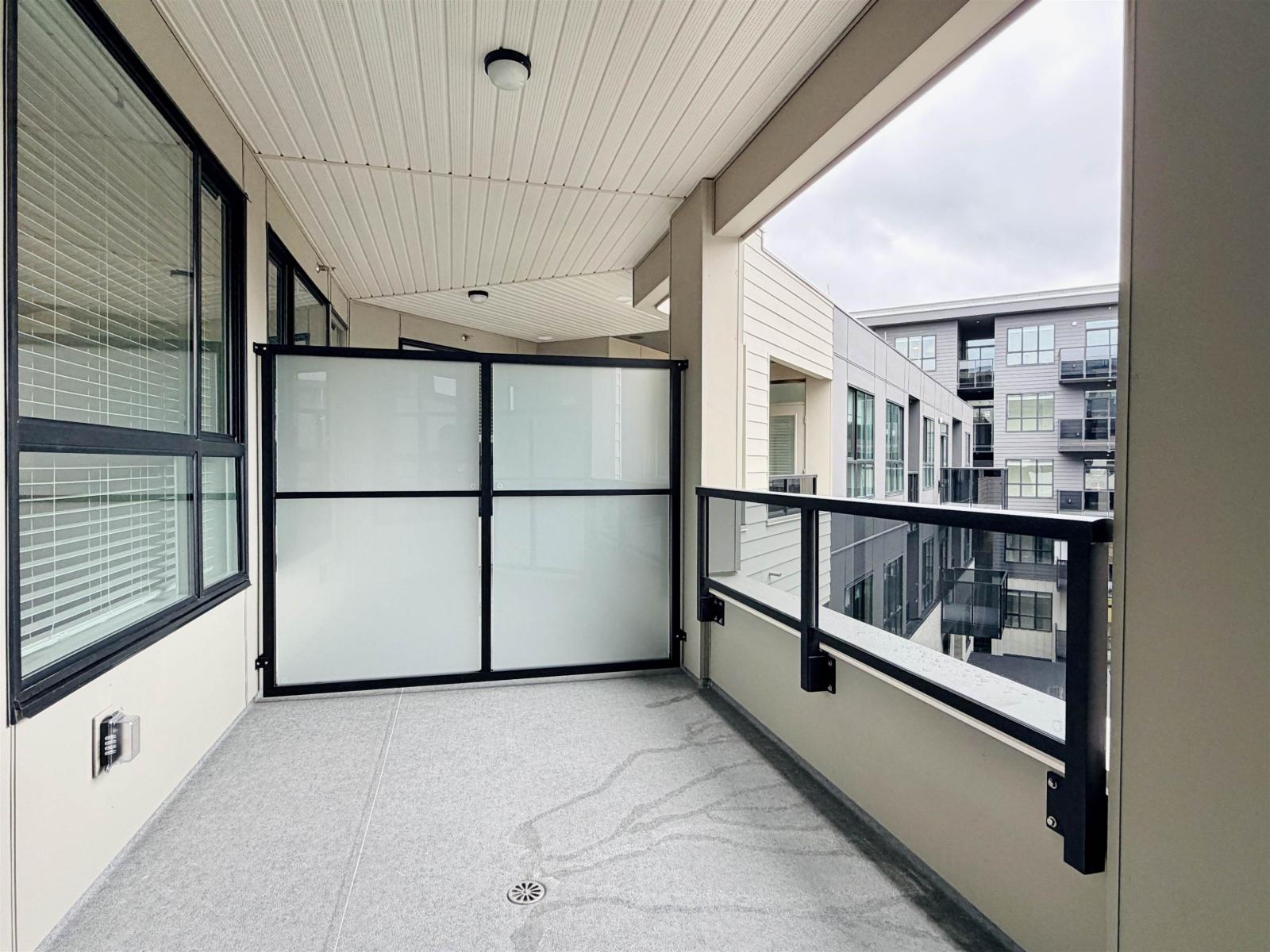 A balcony with glass doors and a white ceiling.