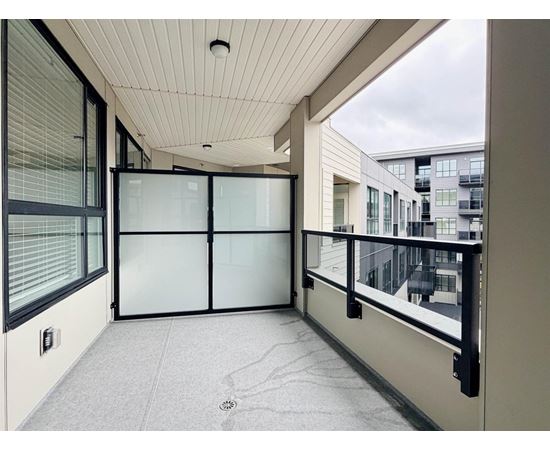 A balcony with glass doors and a white ceiling.