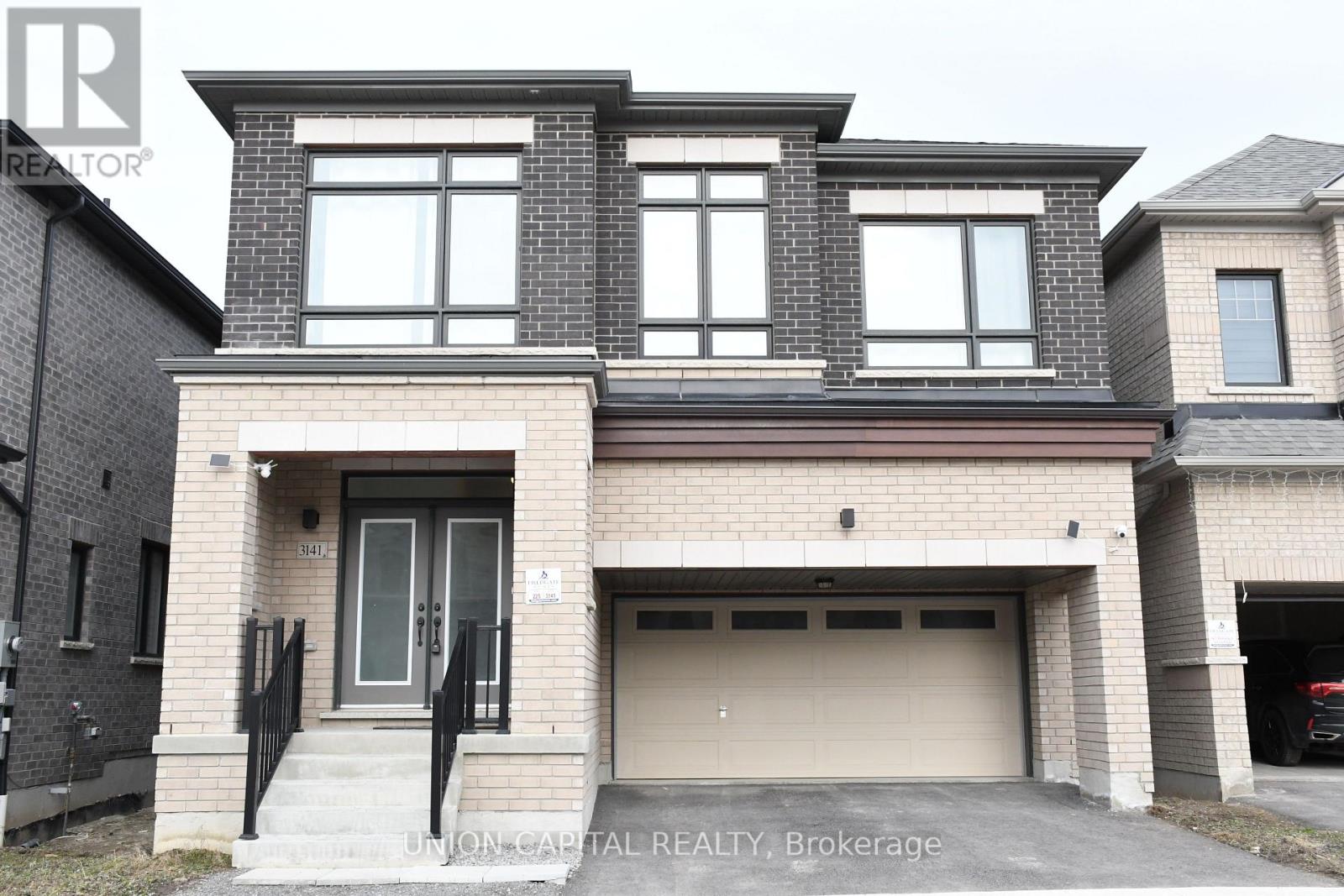 A modern two-story house with a garage is for sale.
