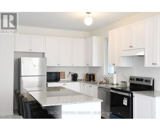 A kitchen with white cabinets and a black stove top oven.