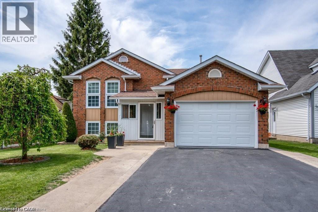 A house with a garage and a driveway in front.