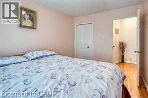 A bedroom with a bed and a door.