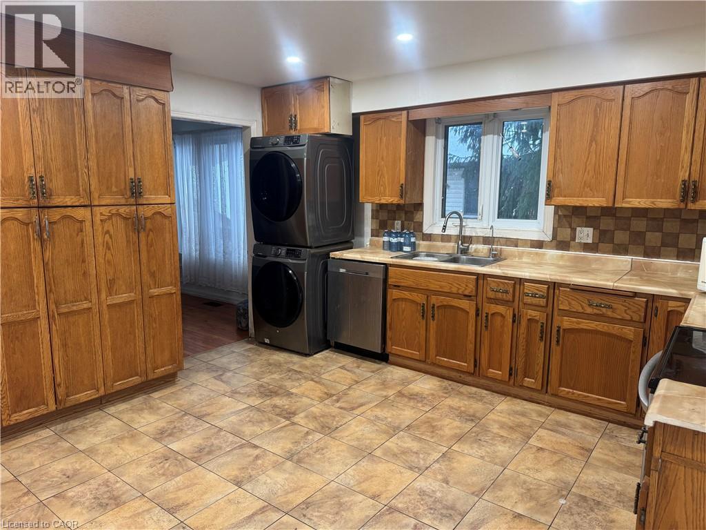 A kitchen with wooden cabinets and a tile floor.