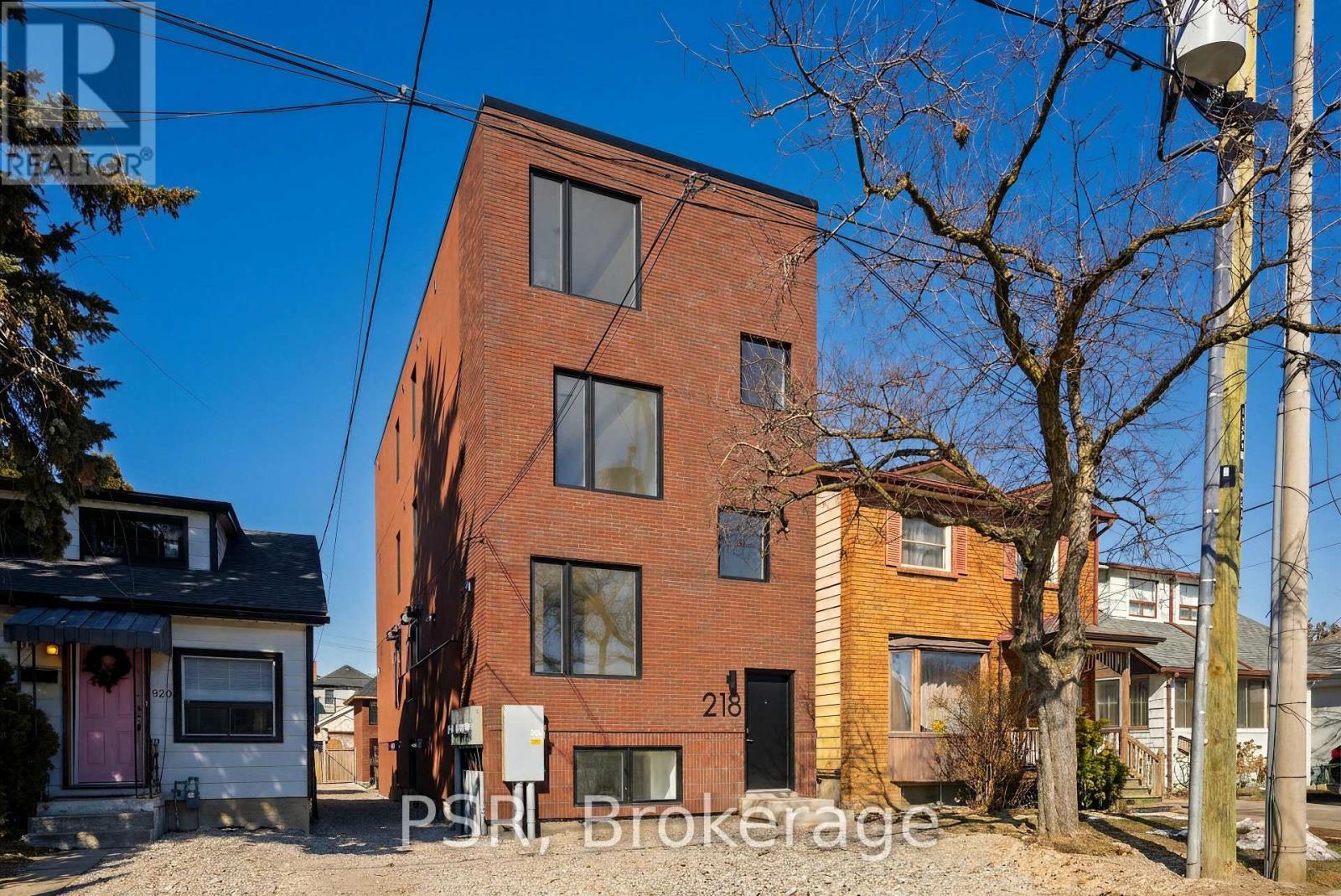 A red brick building with the number 218 on it.