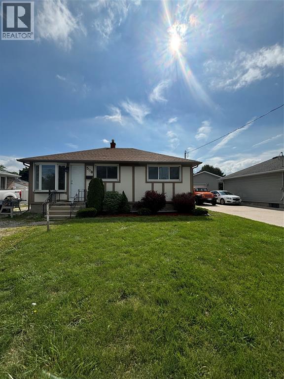 A house with a lawn in front of it is for sale.