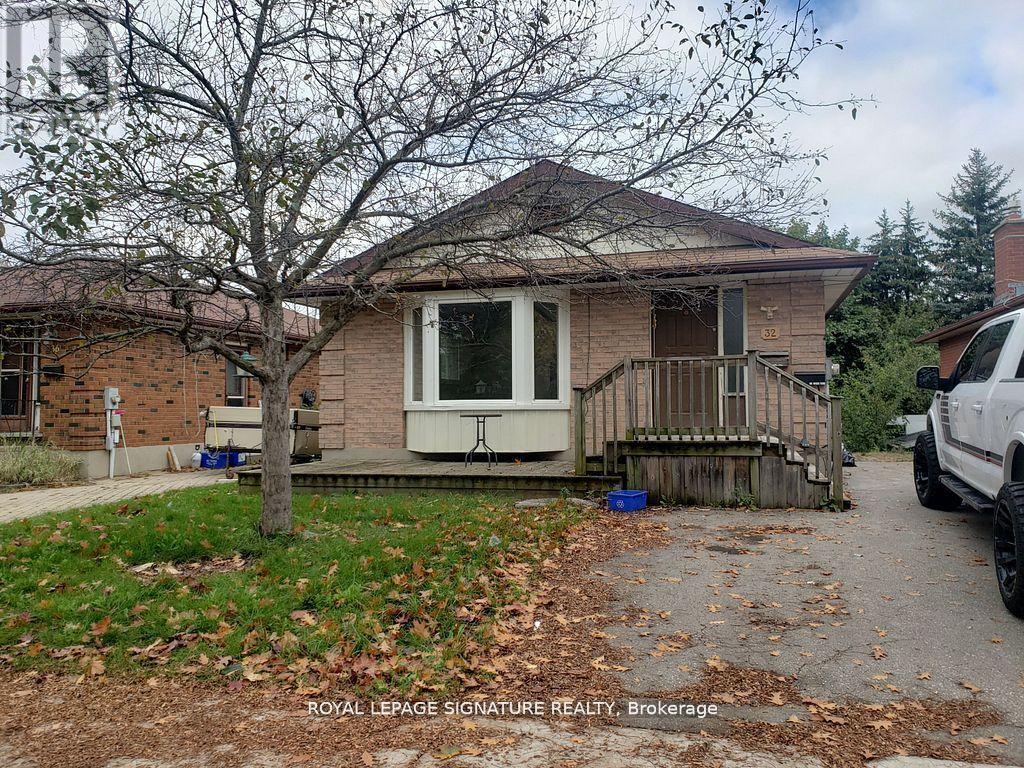 A house with a white door and a tree in front of it.