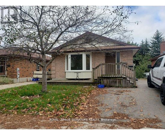 A house with a white door and a tree in front of it.