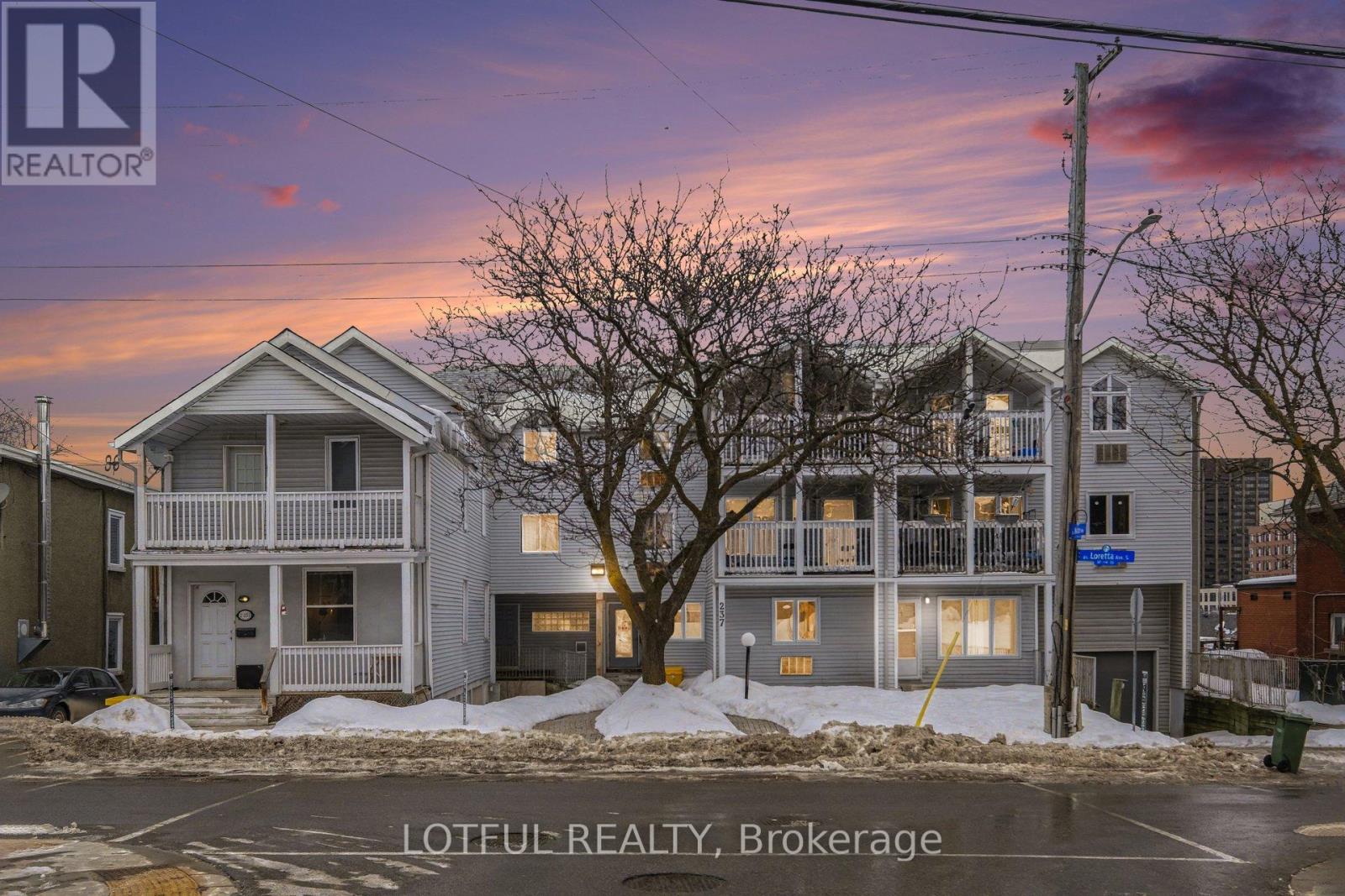 A house with a sign that says "REALTOR" in front of it.