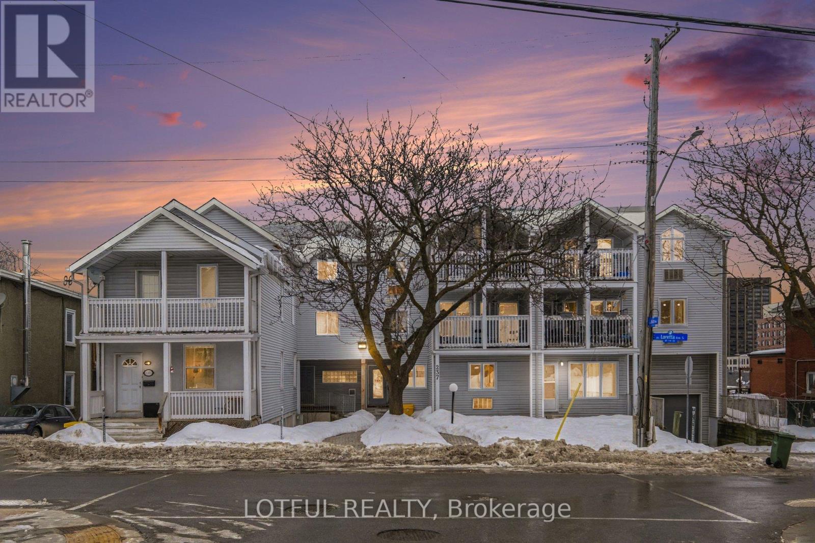 A house with a sign that says "REALTOR" in front of it.