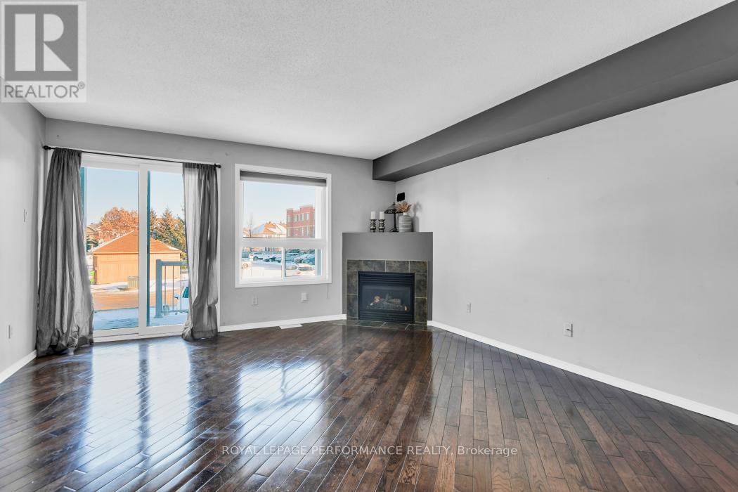 A spacious living room with a fireplace and sliding glass doors.