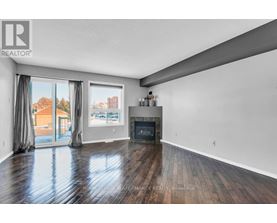 A spacious living room with a fireplace and sliding glass doors.