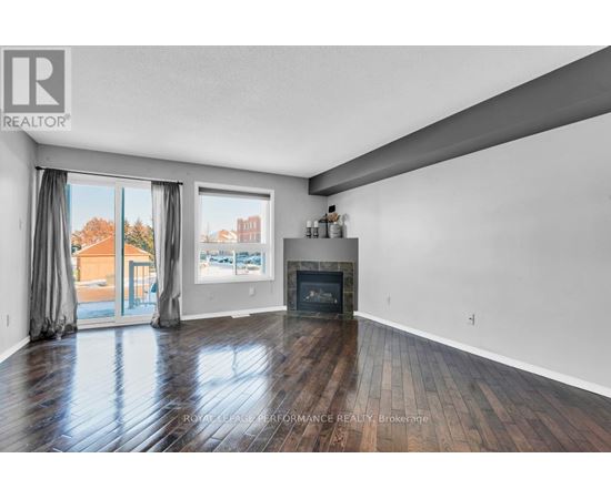 A spacious living room with a fireplace and sliding glass doors.