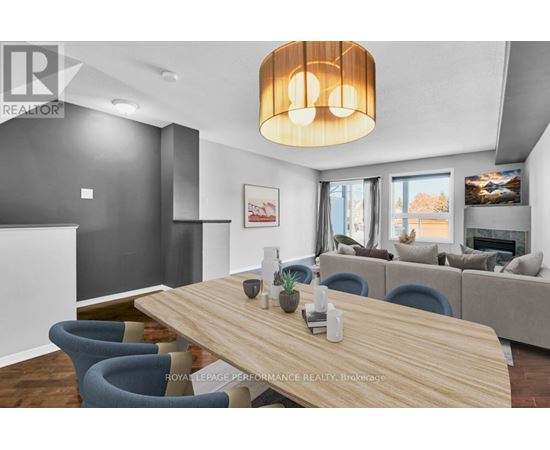 A modern dining room with a wooden table and blue chairs.