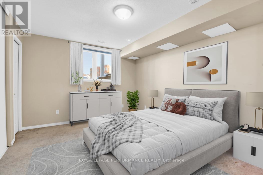 A bedroom with a large bed and a small kitchenette.