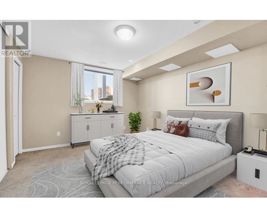 A bedroom with a large bed and a small kitchenette.