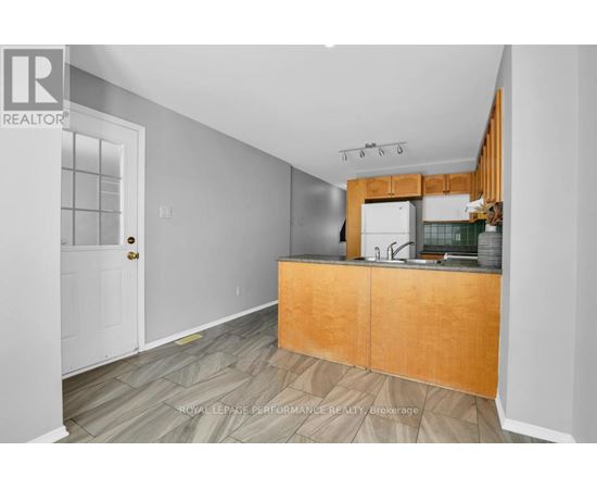 A kitchen with a wooden counter and a sink.