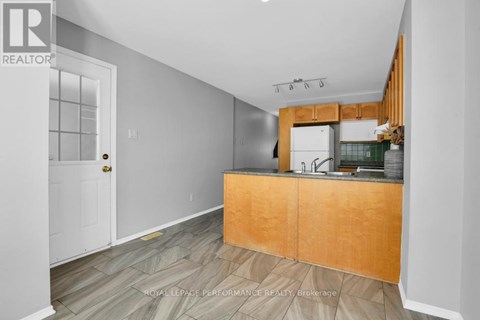 A kitchen with a wooden counter and a sink.