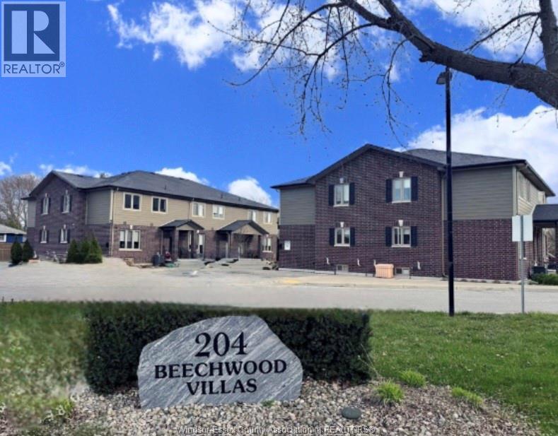 A real estate sign for Beechwood Villas in front of a building.