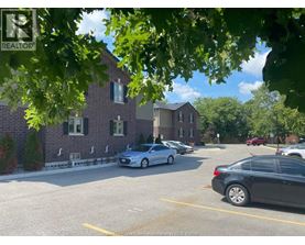 A parking lot with cars and a building in the background.