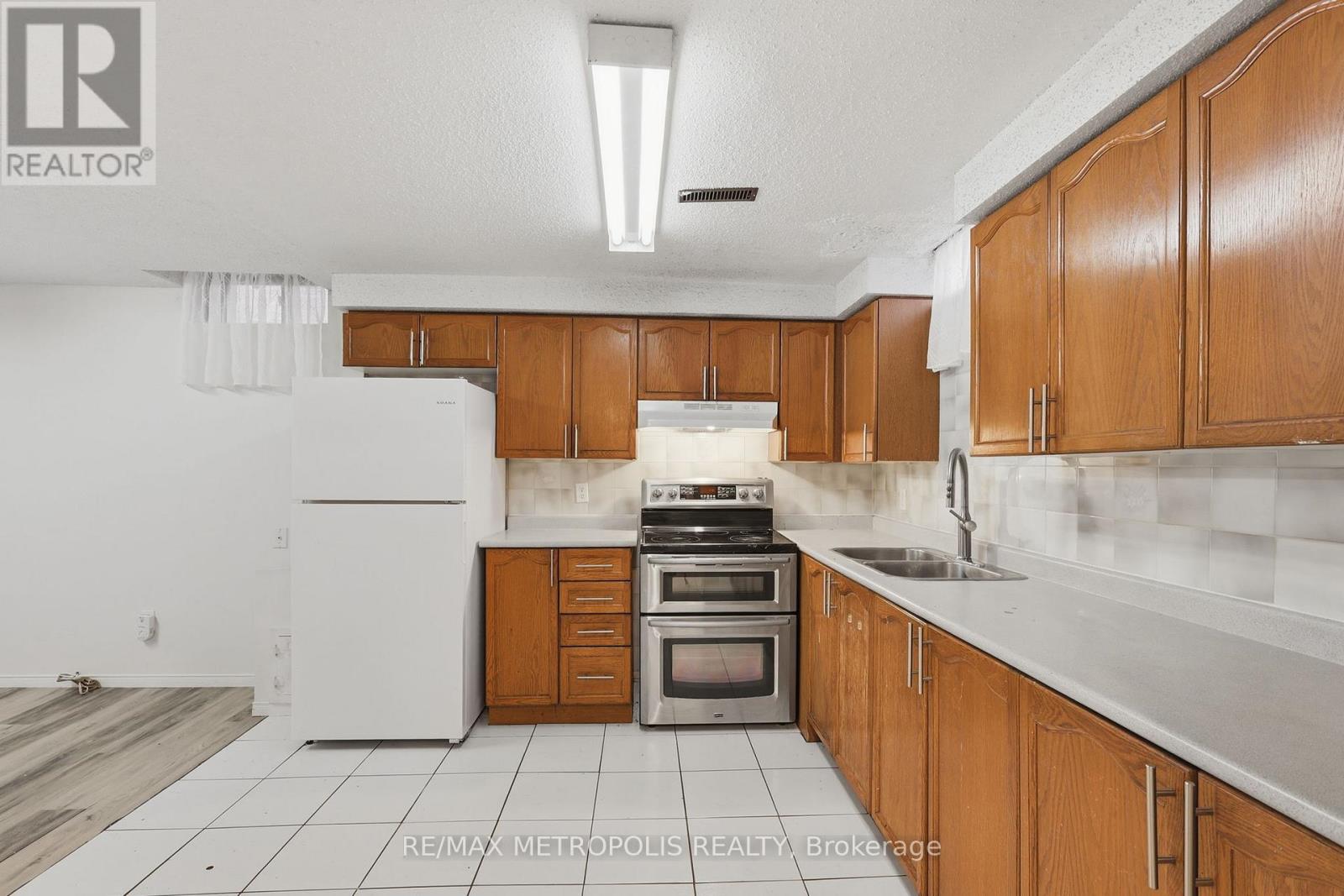 A kitchen with wooden cabinets and a white refrigerator.