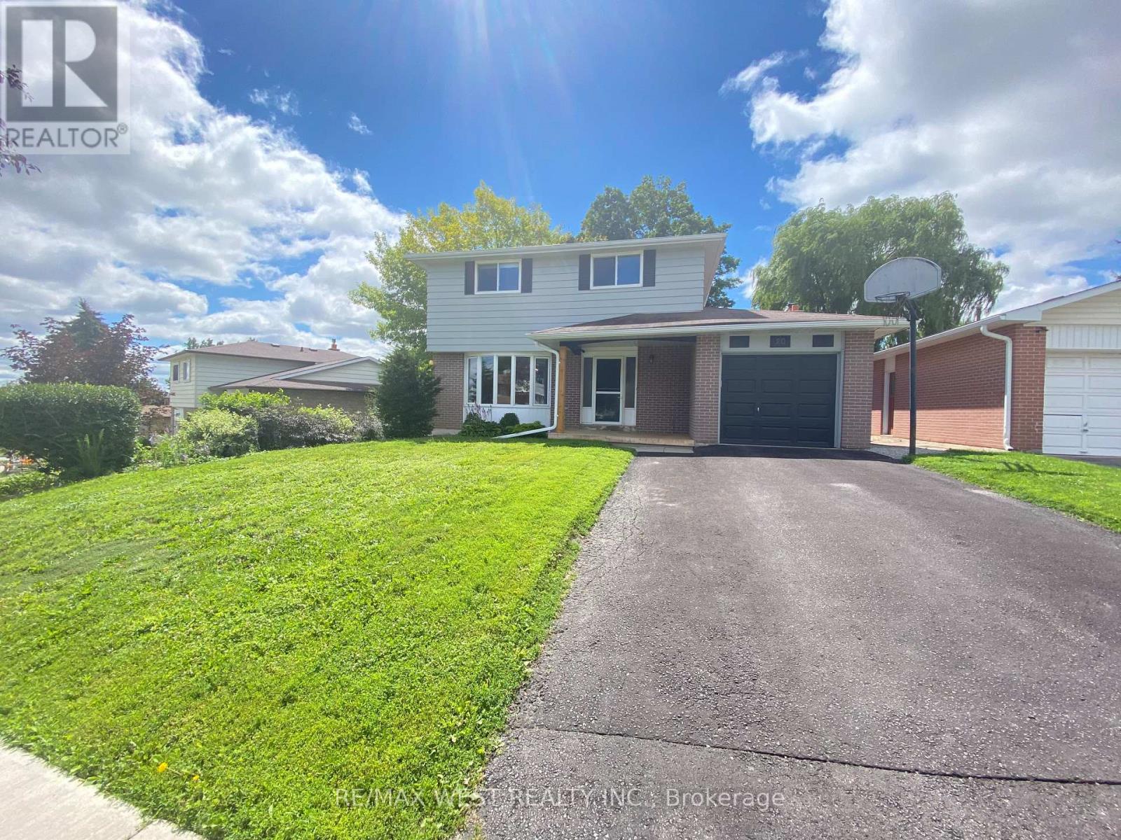 A house with a driveway in front of it is for sale.