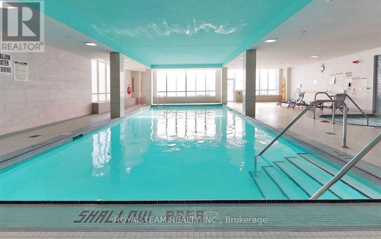 A large indoor swimming pool with a glass bottom.