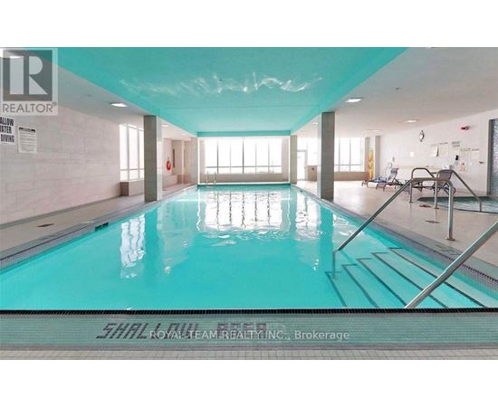 A large indoor swimming pool with a glass bottom.