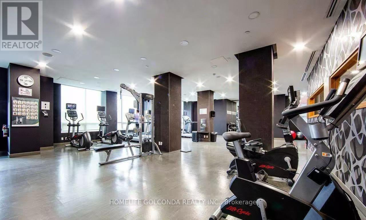A gym with a variety of equipment including treadmills and weights.