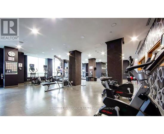 A gym with a variety of equipment including treadmills and weights.