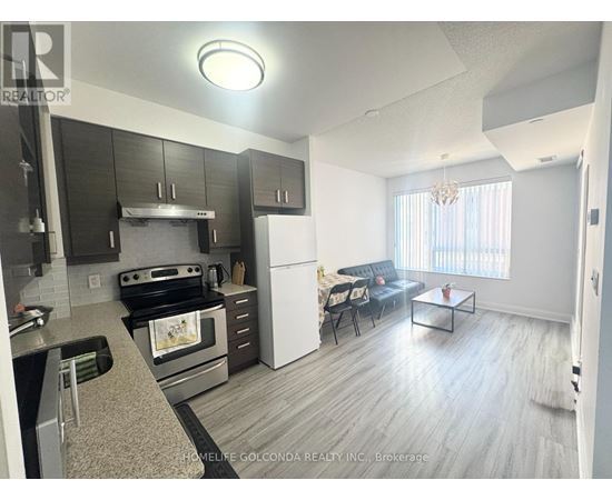 A modern kitchen with a stove top oven and a refrigerator.