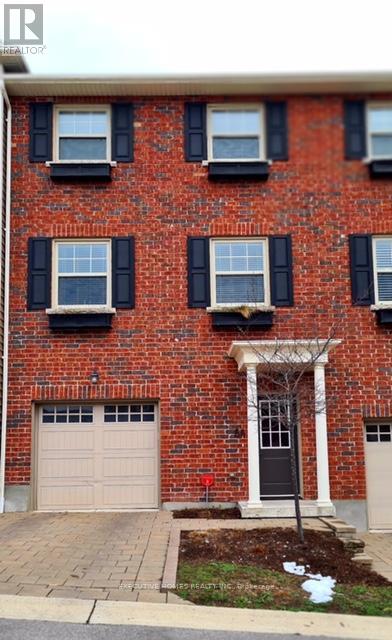 A red brick building with black shutters and a white door.