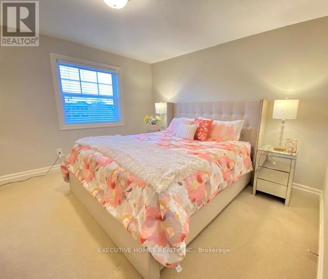 Bedroom with a bed, nightstand, and window.