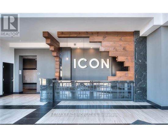 A modern interior space with a staircase and a reception desk.