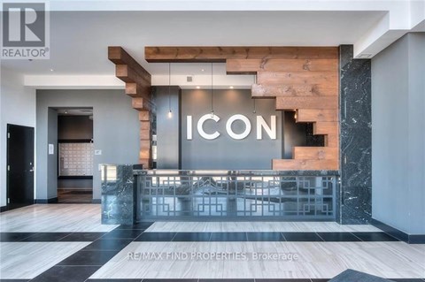 A modern interior space with a staircase and a reception desk.