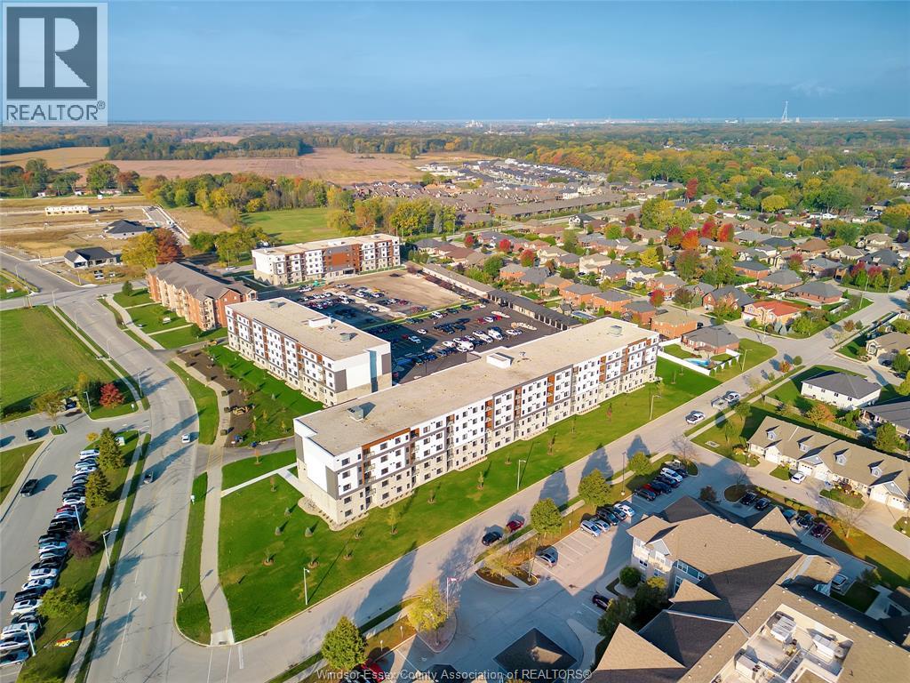 An aerial view of a large building complex with a parking lot in front.