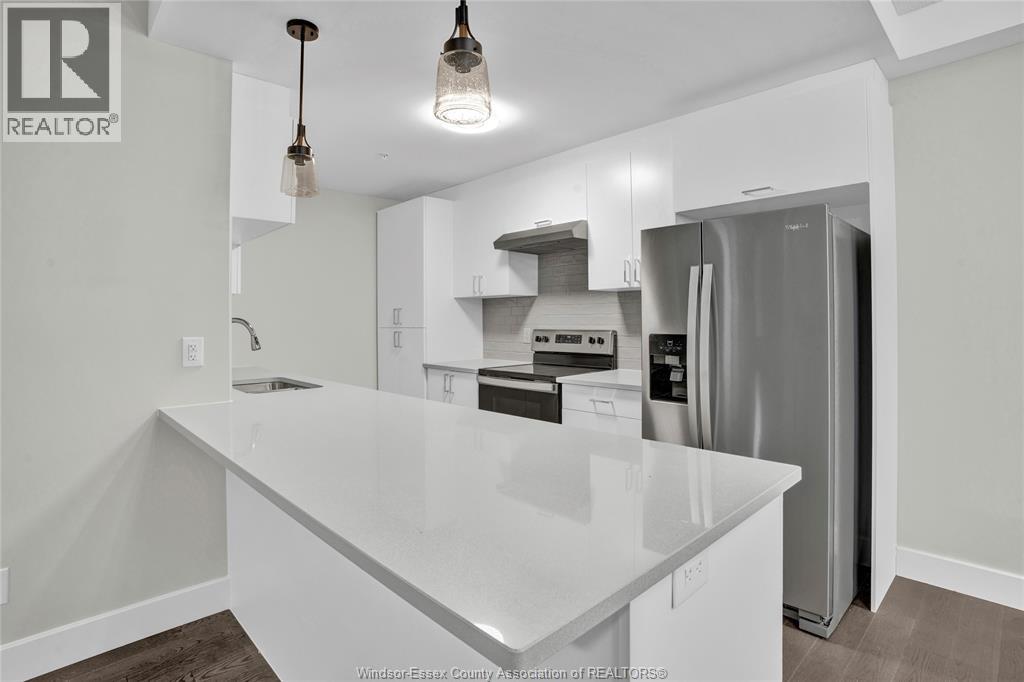 A kitchen with a white countertop and a refrigerator.