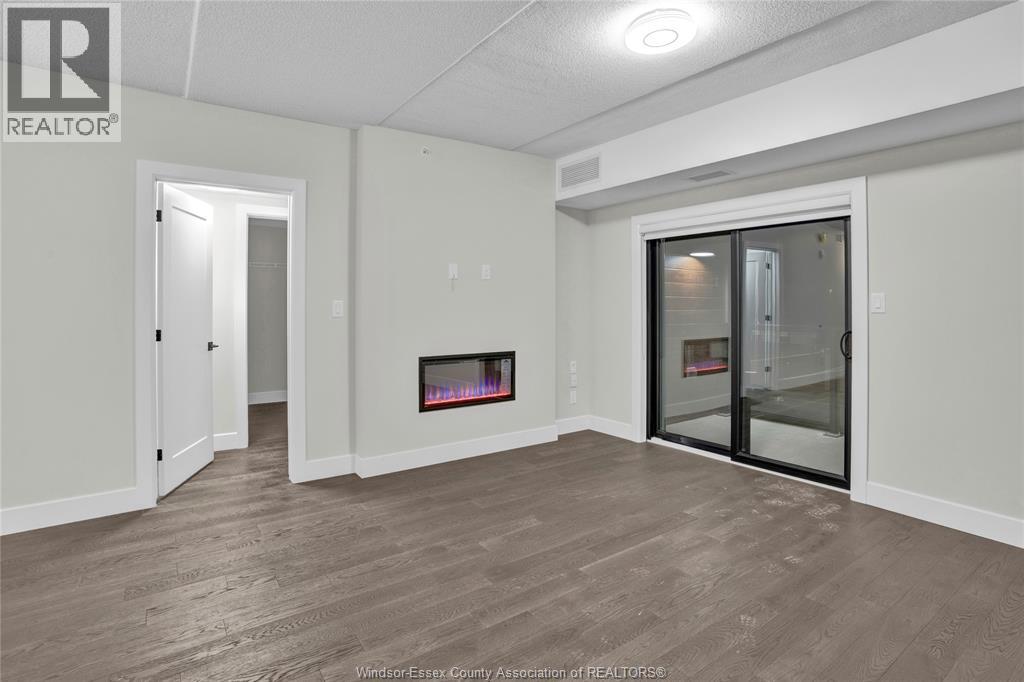 A spacious room with a fireplace and sliding glass doors.